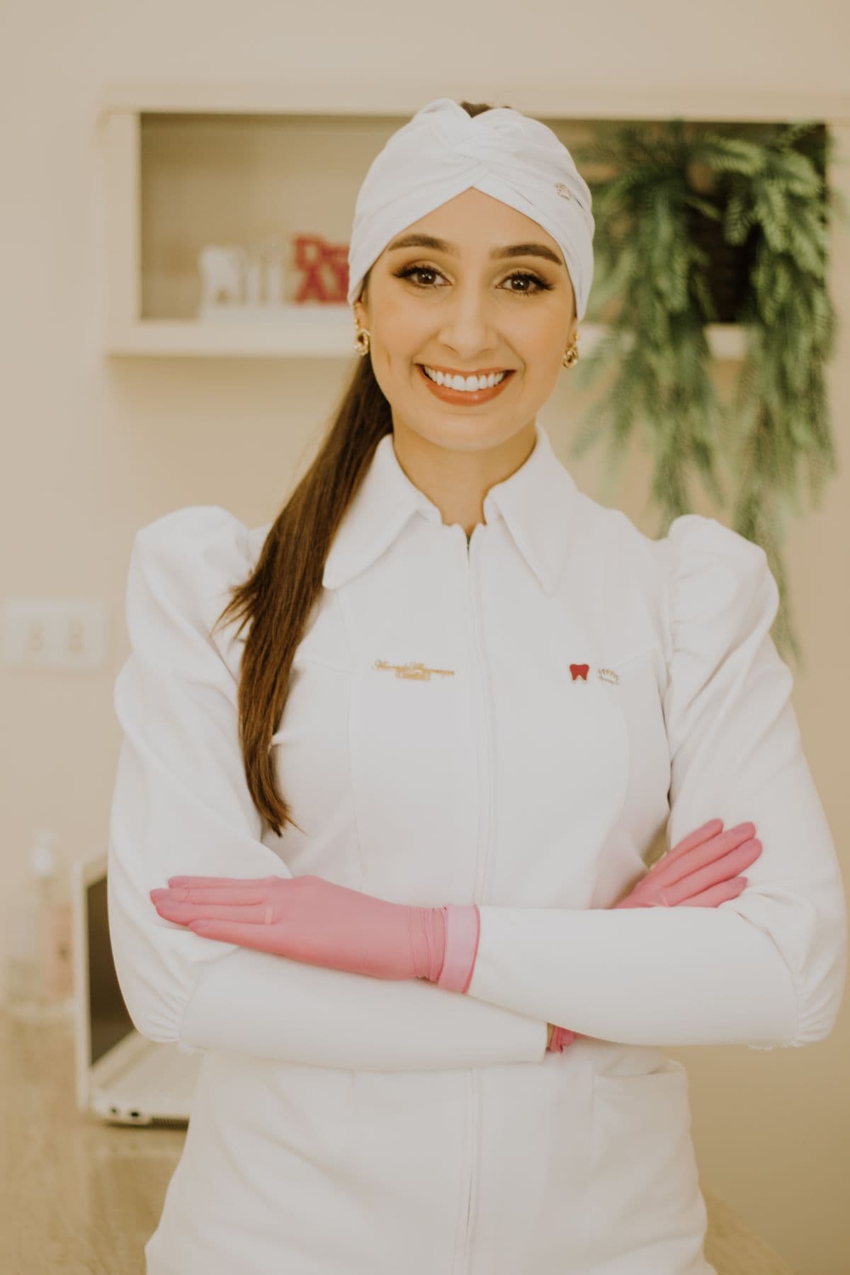 Smiling dentist in a white clinical uniform